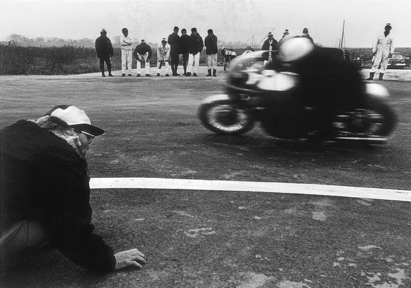 Soichiro Honda sensing the track and his motorcycles